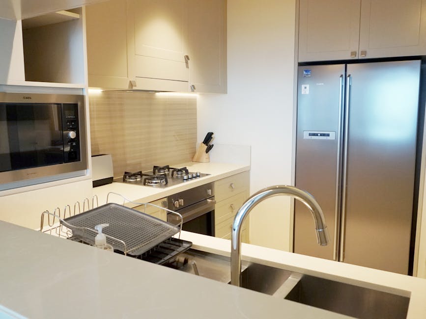 A stylish modern kitchen featuring stainless steel appliances and sleek design elements.