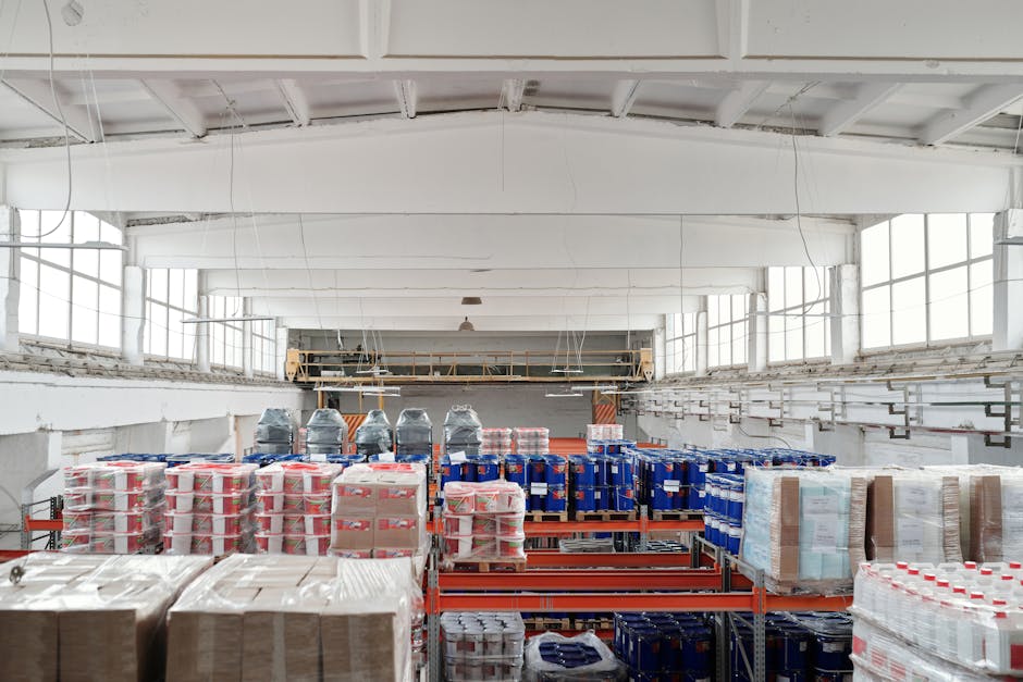 Spacious warehouse interior featuring organized shelves with various stacked pallets.